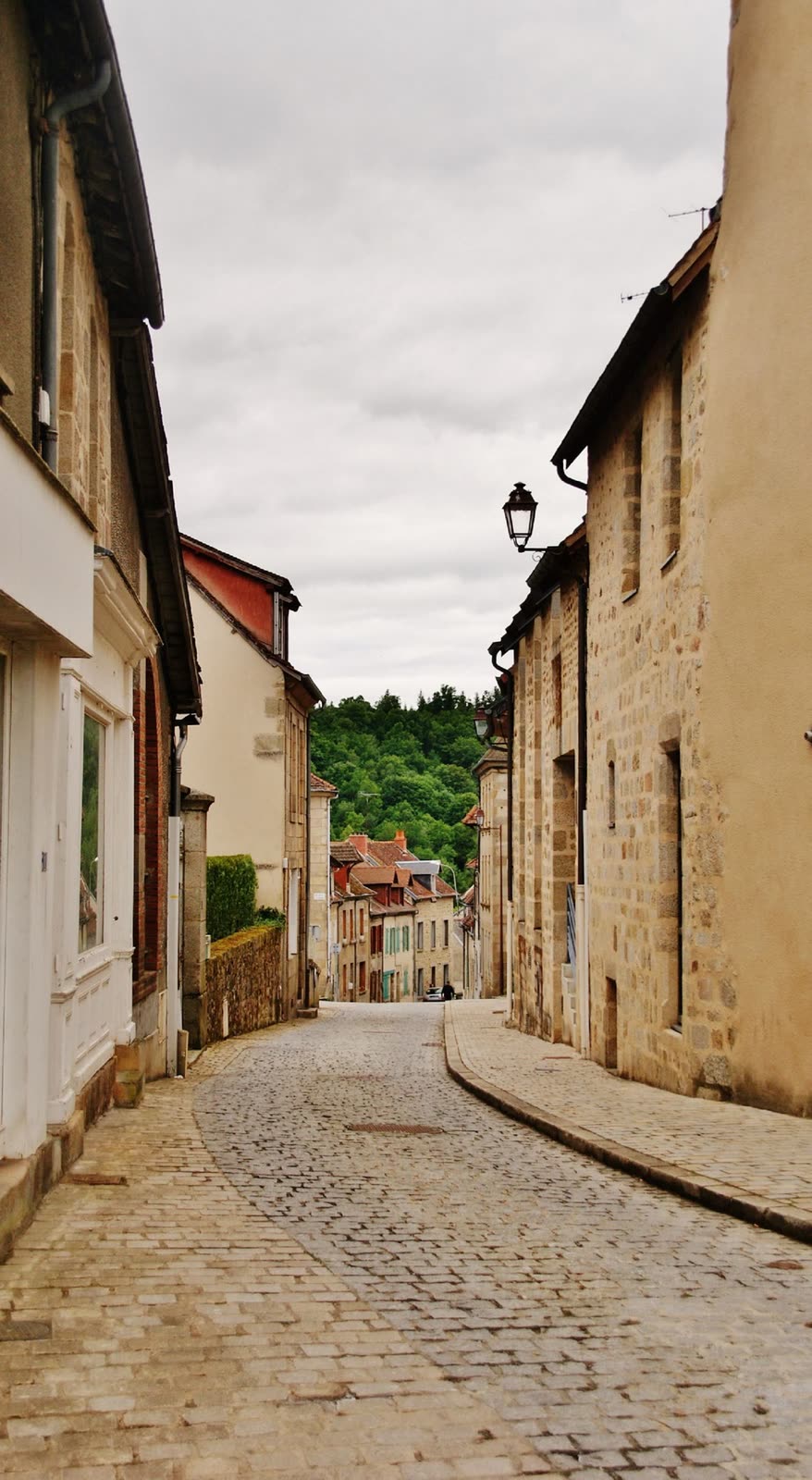 Ruelle pavée bordée de maisons anciennes dans un bourg du Limousin